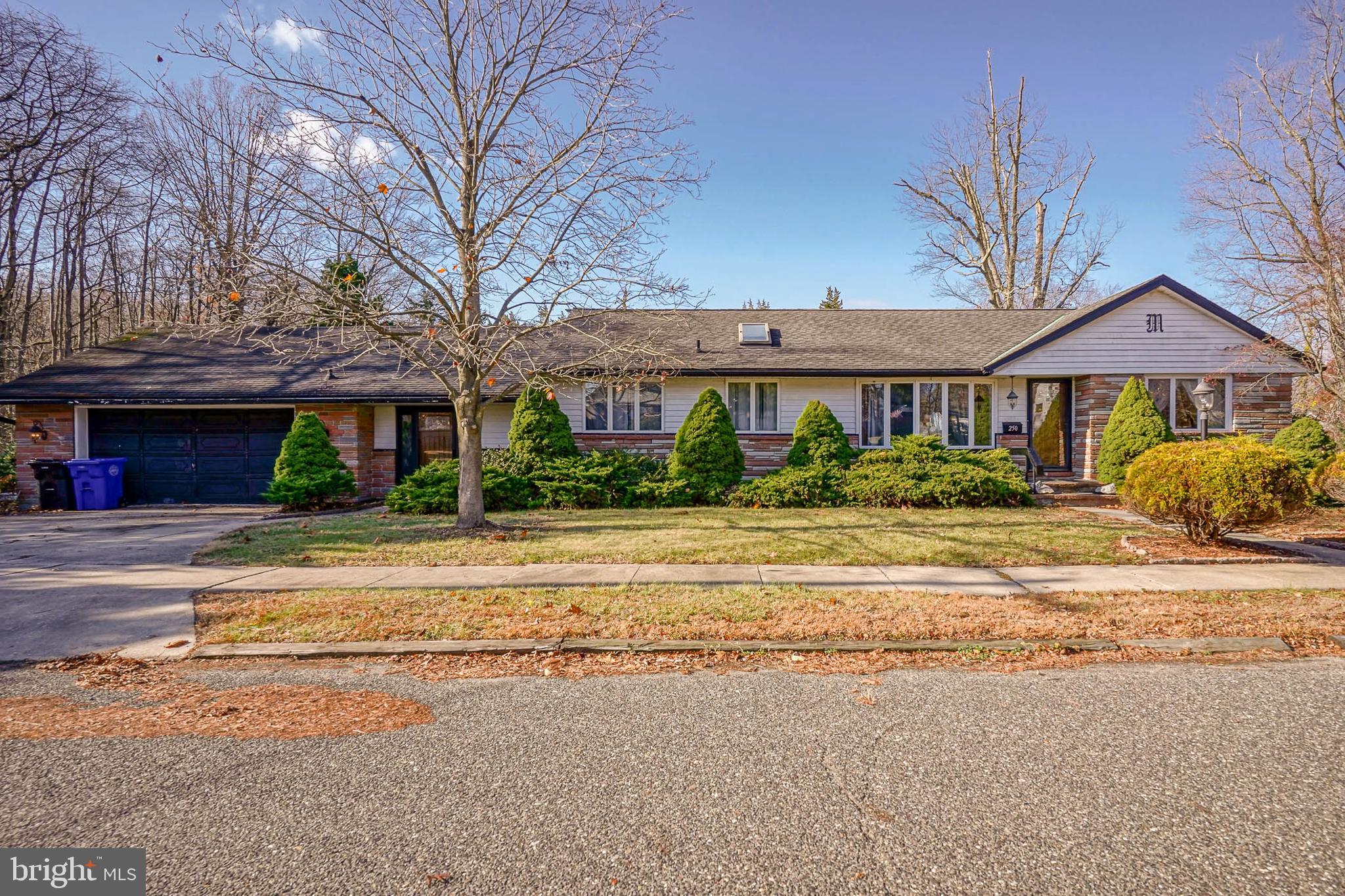 a front view of a house with a yard and outdoor seating