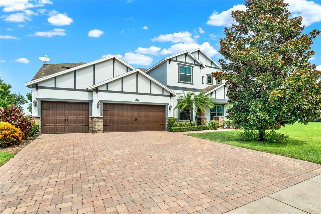 a front view of a house with a yard and garage