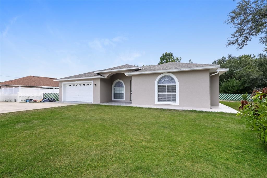 a view of a house with a backyard