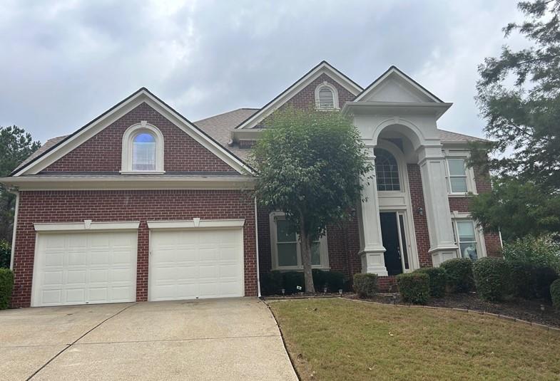 a front view of a house with garage