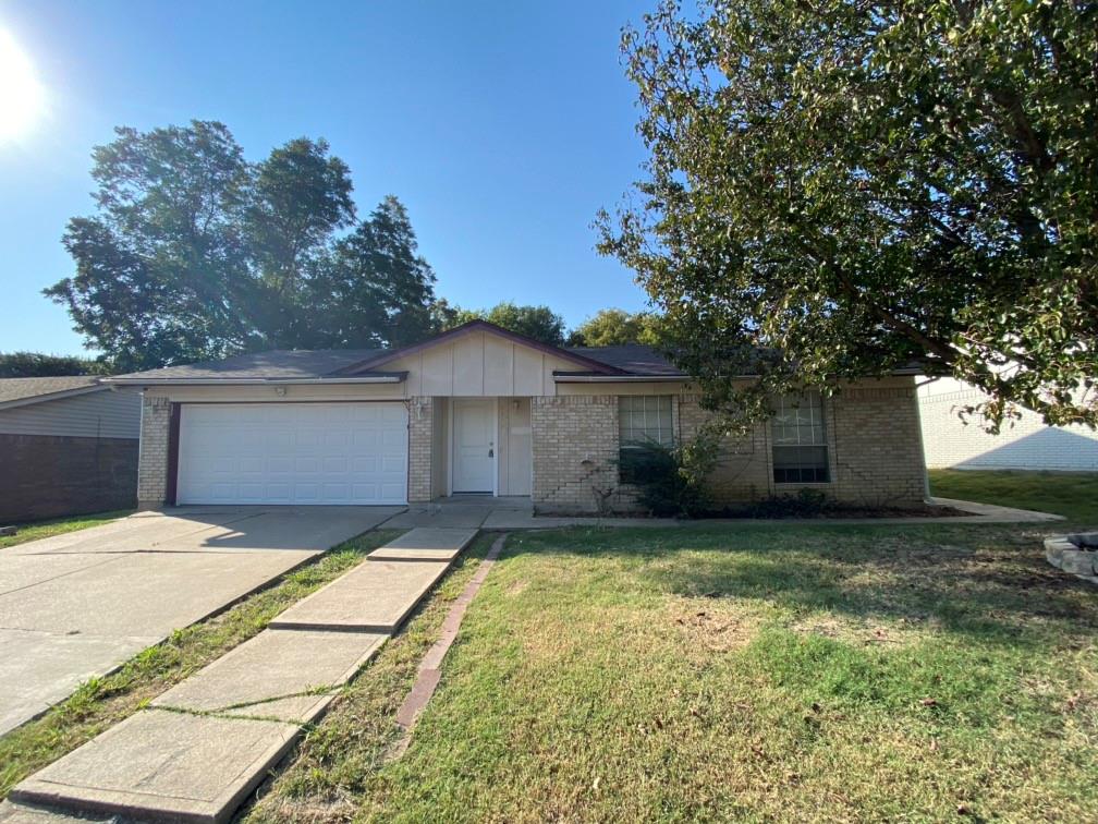 a view of a house with a yard and tree