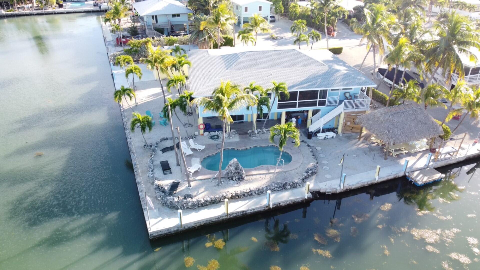 an aerial view of house with yard swimming pool and outdoor seating