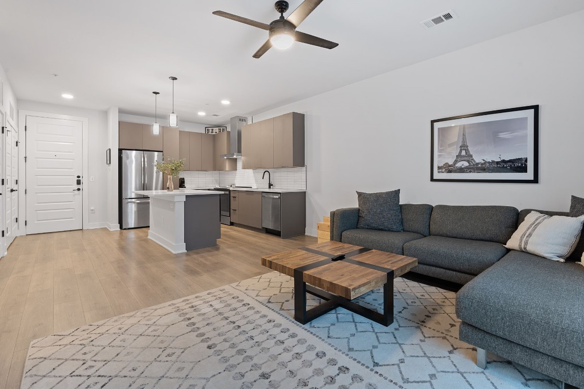 a living room with furniture and kitchen view