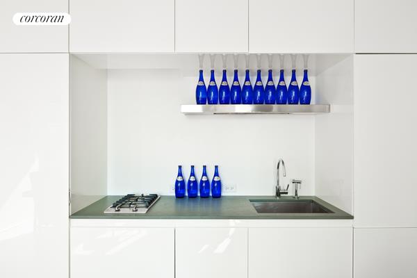 a kitchen with a sink and a stove top oven