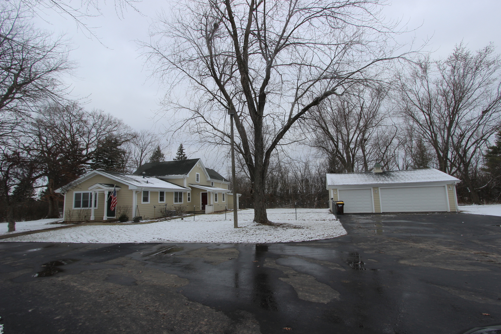 a front view of house with yard and trees