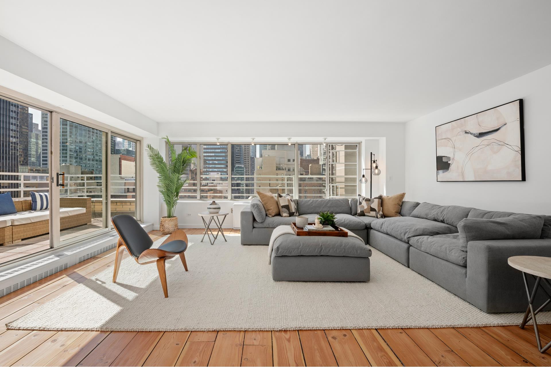 a living room with furniture and a large window with balcony view