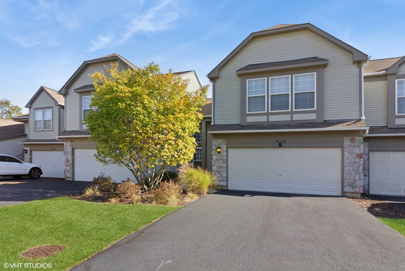 a front view of a house with a yard and garage