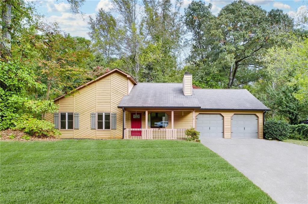 a view of a house with a backyard