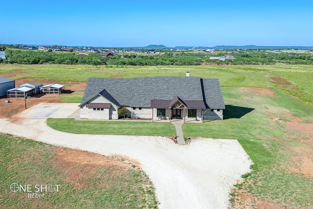 an aerial view of a house with outdoor space and a lake view