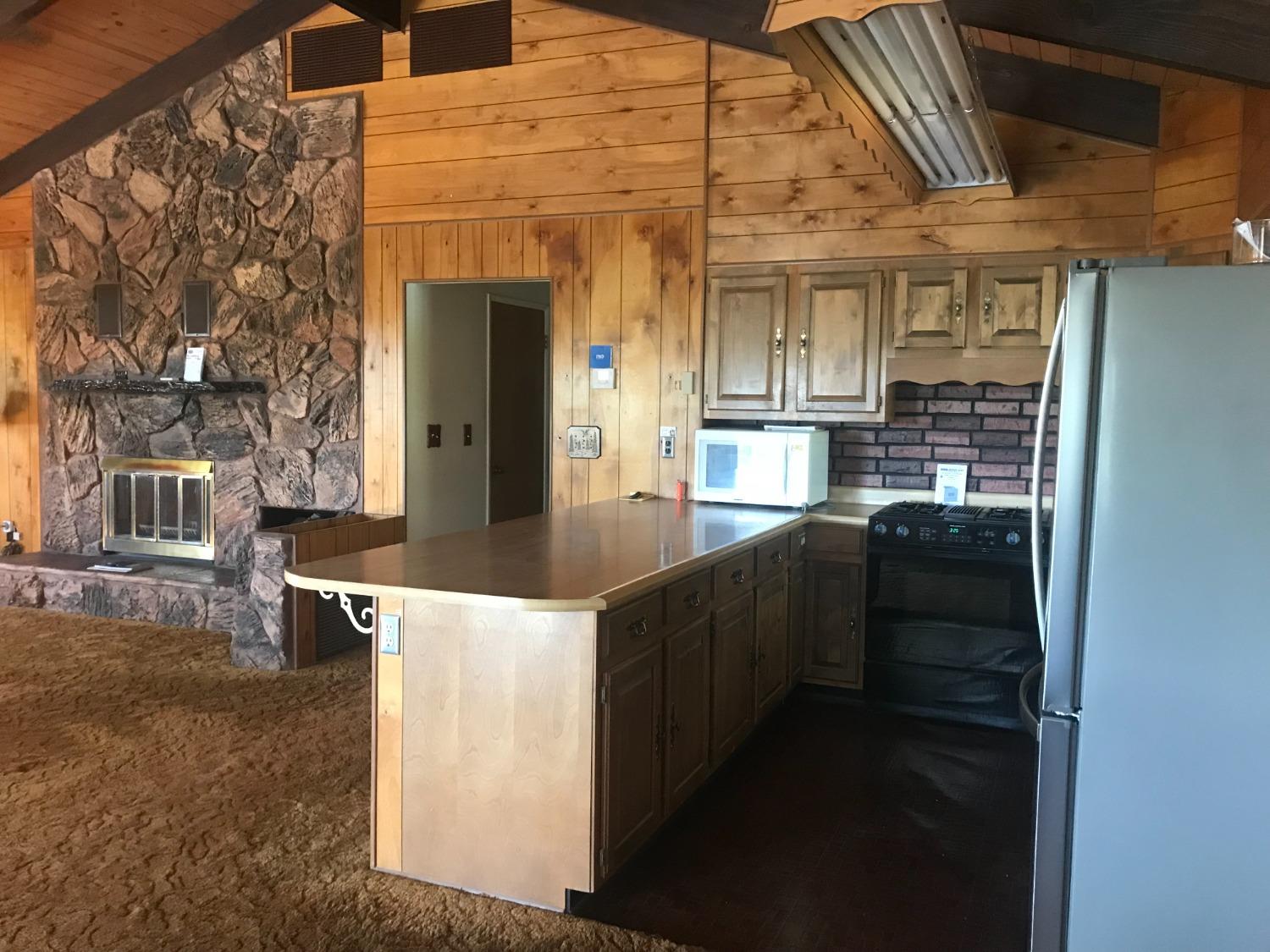 a kitchen with kitchen island cabinets and stove