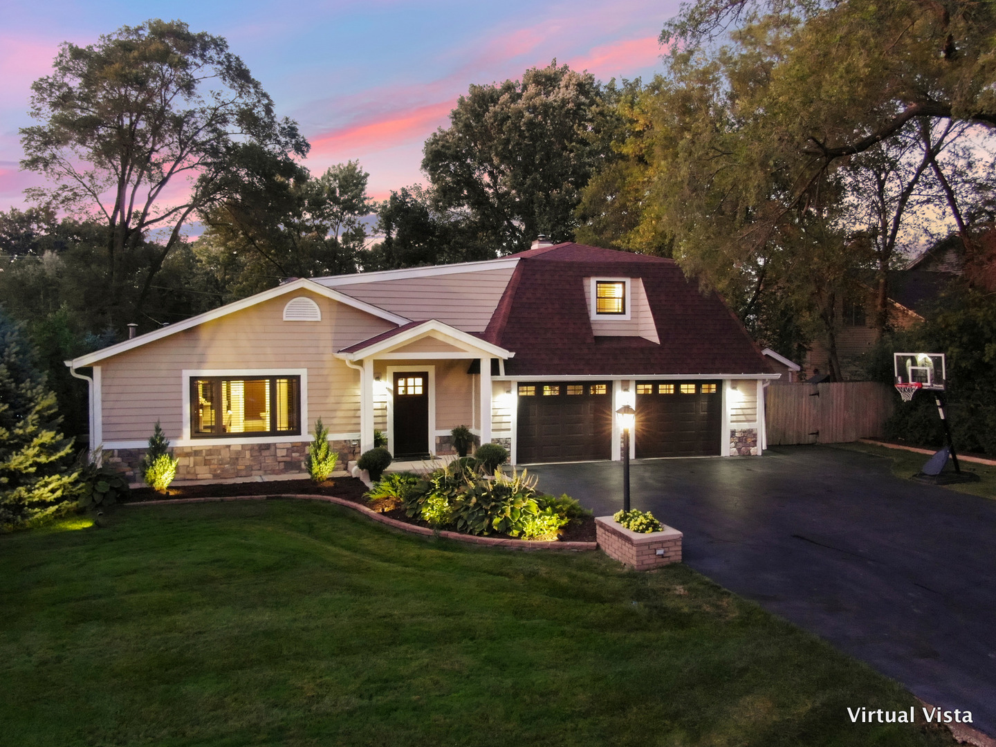 a front view of a house with a garden