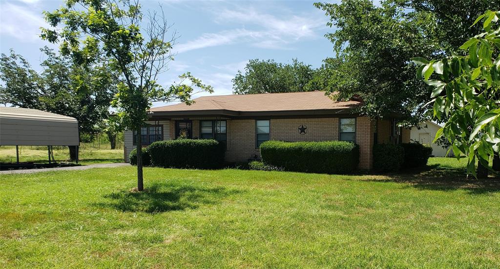 a view of a house with a yard and tree s