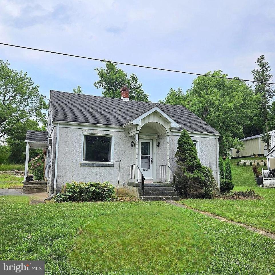 a front view of house with yard and green space