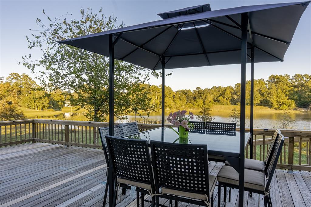 a view of a roof deck with furniture and umbrella