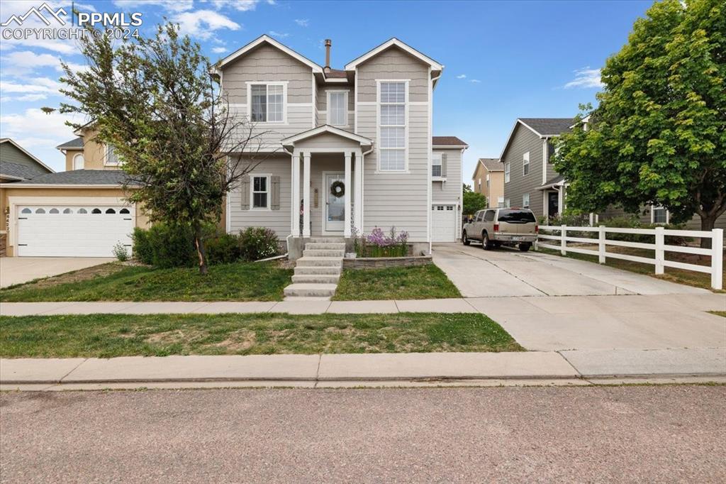 a front view of a house with a yard