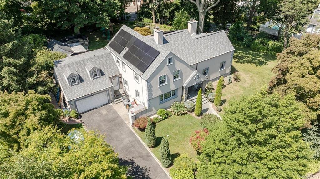 an aerial view of a house with a yard