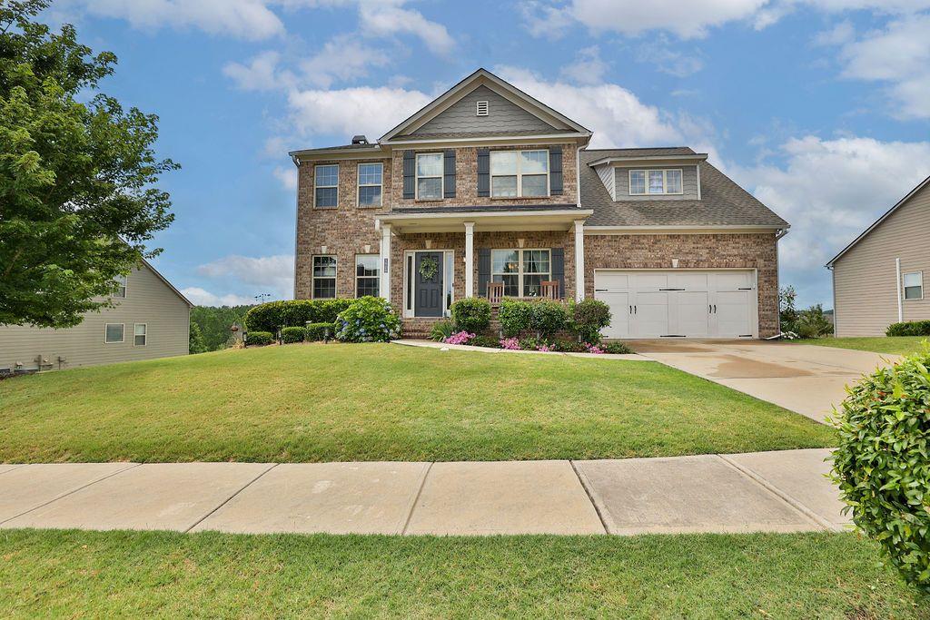 a front view of a house with a yard