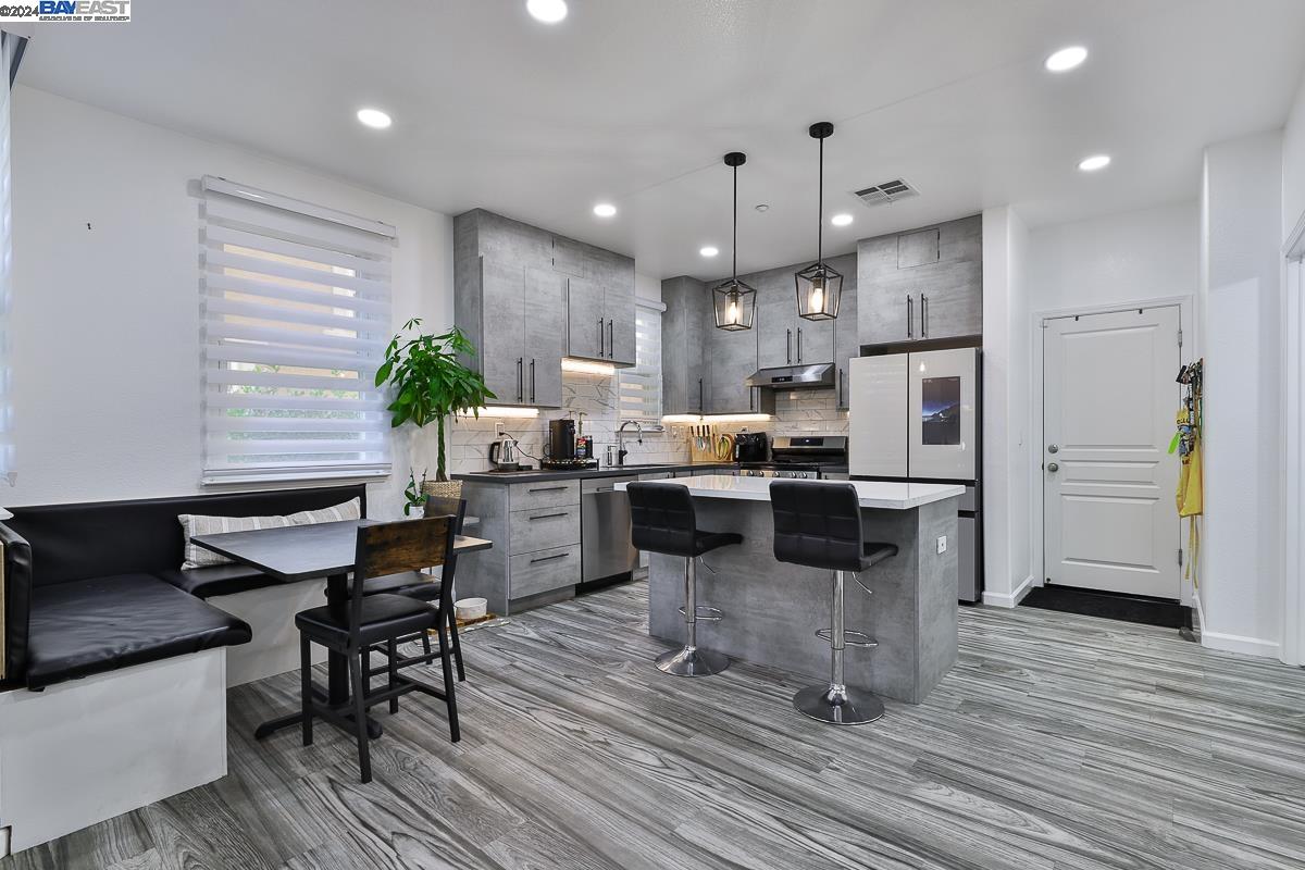 a kitchen with a refrigerator and a table