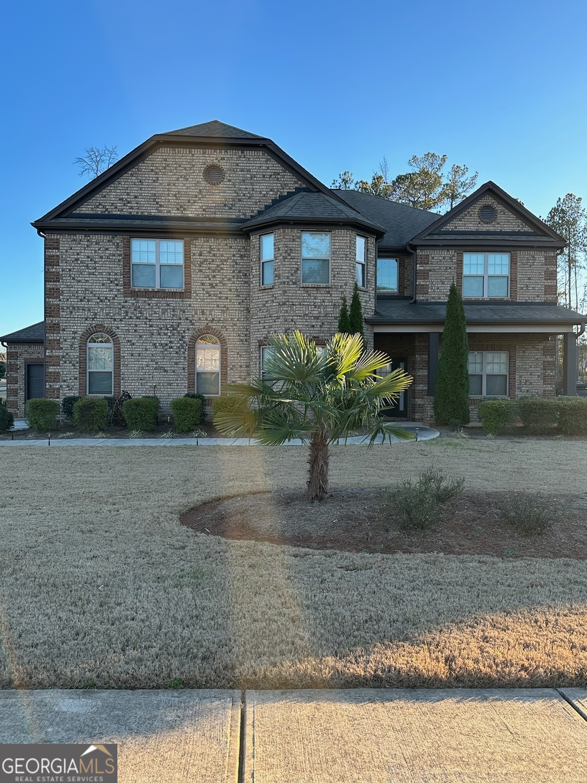 a front view of a house with a yard