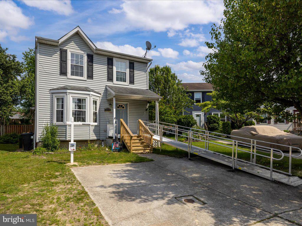 a front view of a house with a yard table and chairs