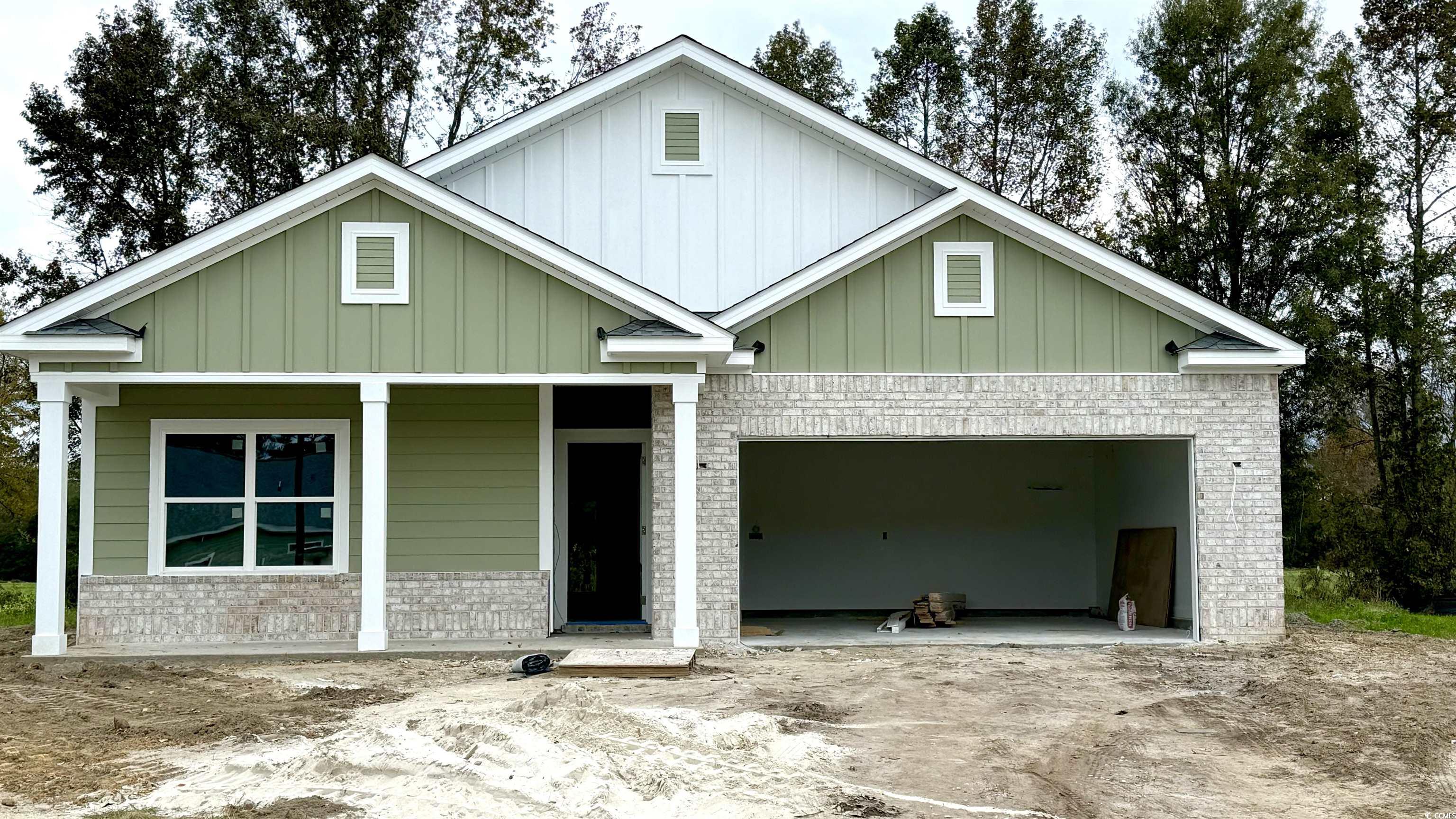 View of front facade with a porch and a garage