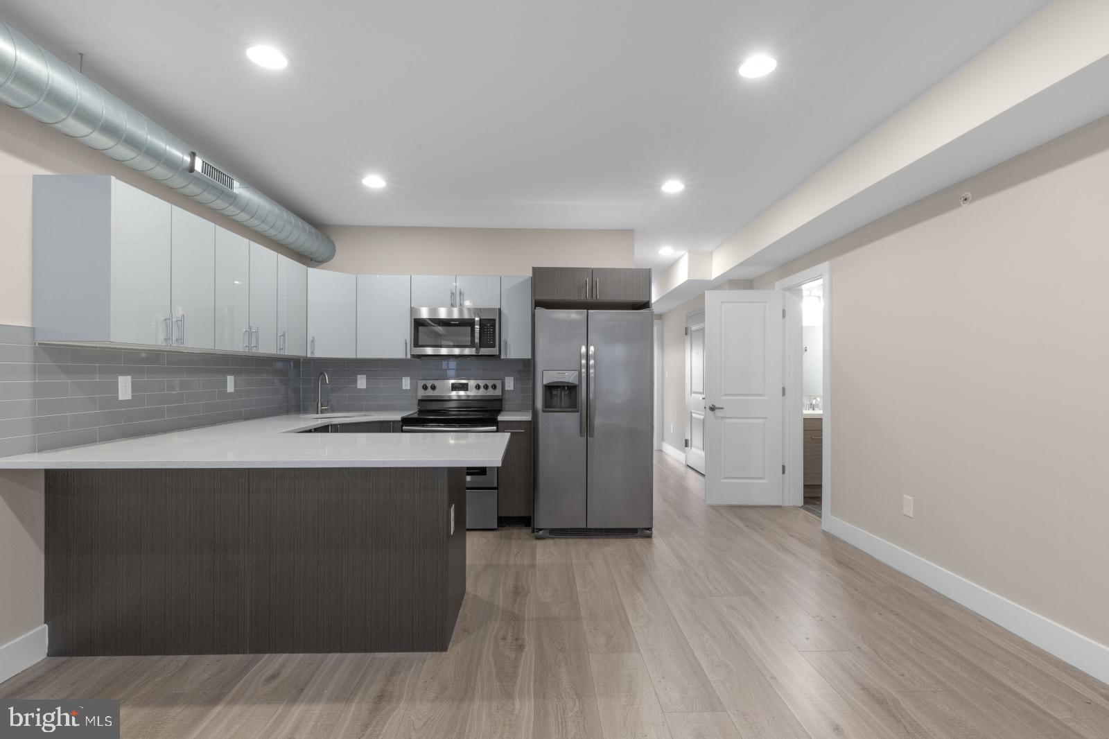 a kitchen with a refrigerator a sink and cabinets