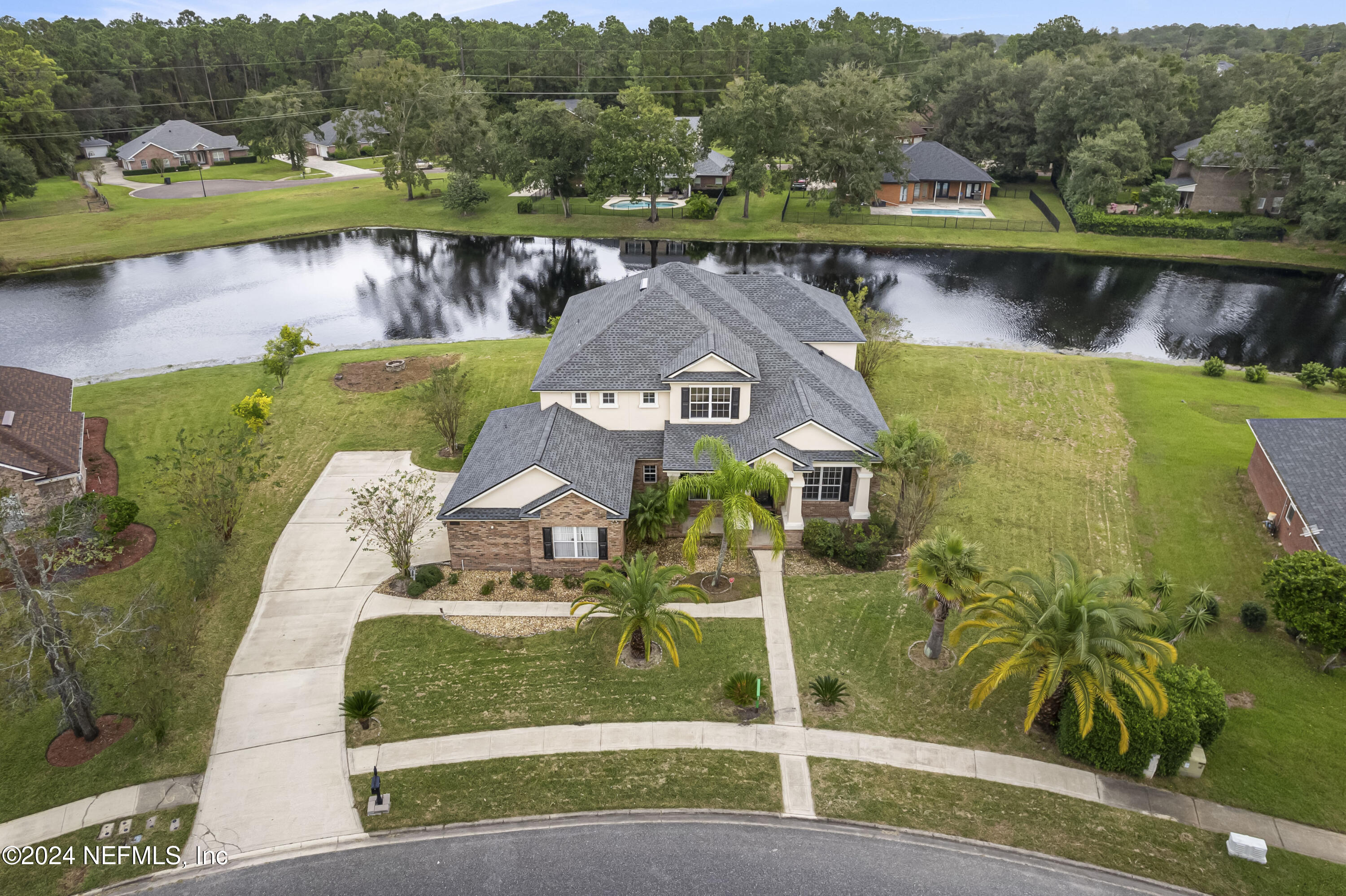 an aerial view of a house with a lake view