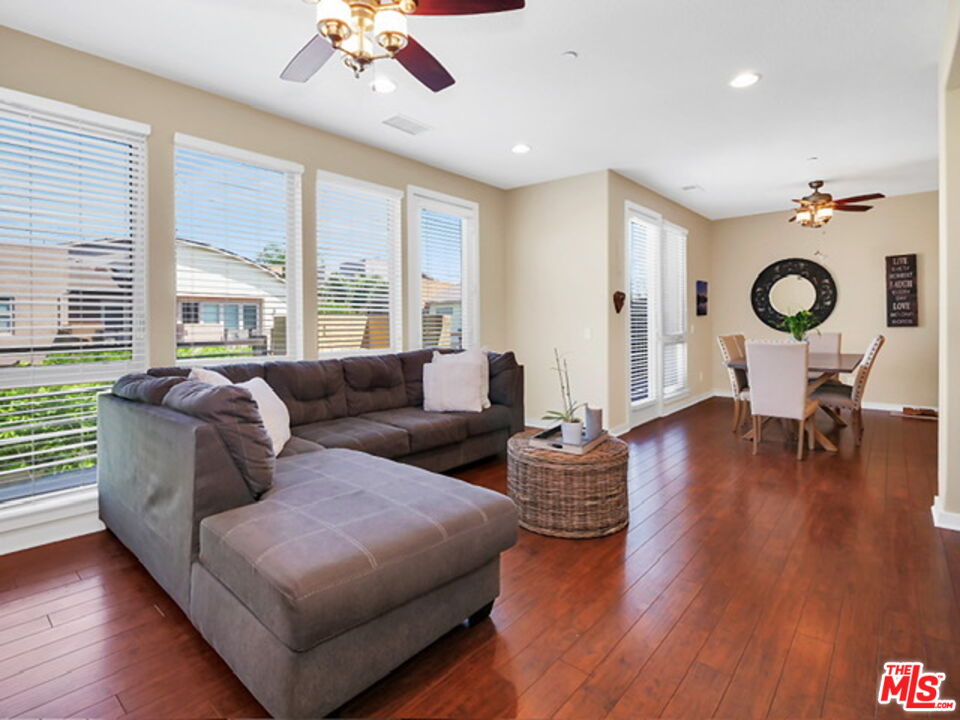 a living room with fireplace furniture and a large window