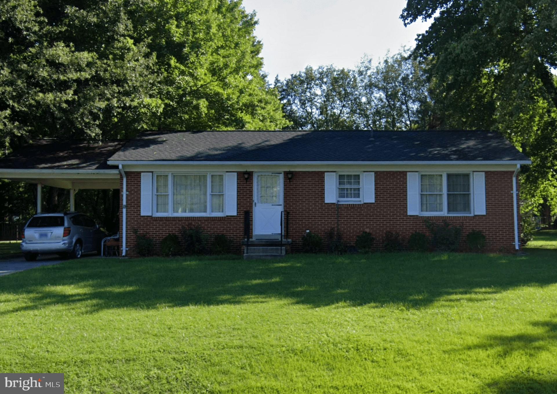 a view of a house with a yard porch and sitting area