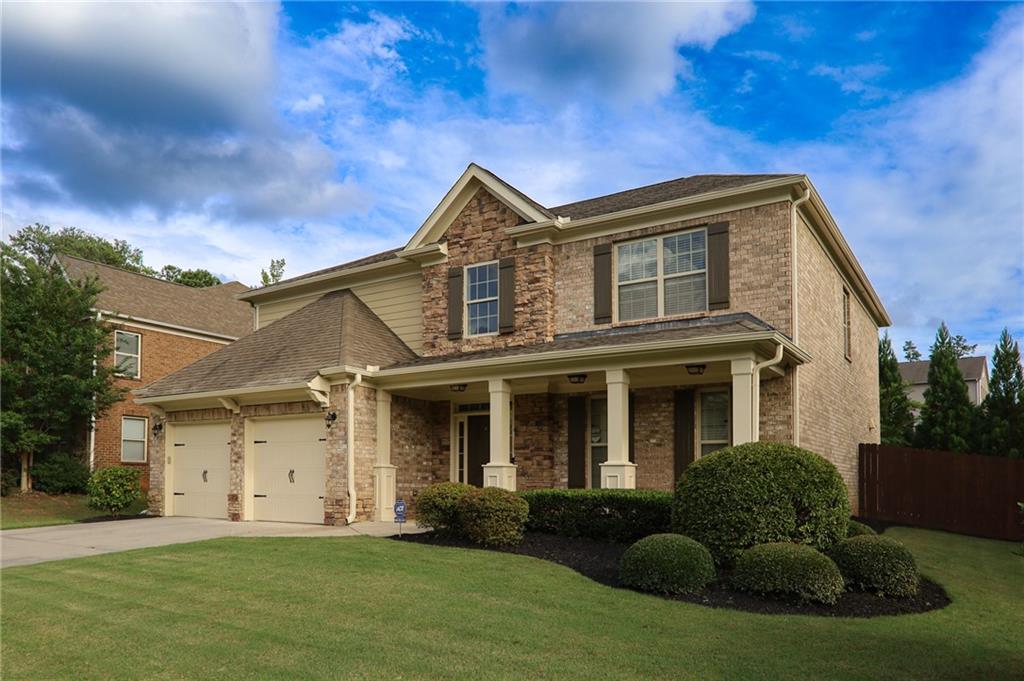 a front view of a house with a yard