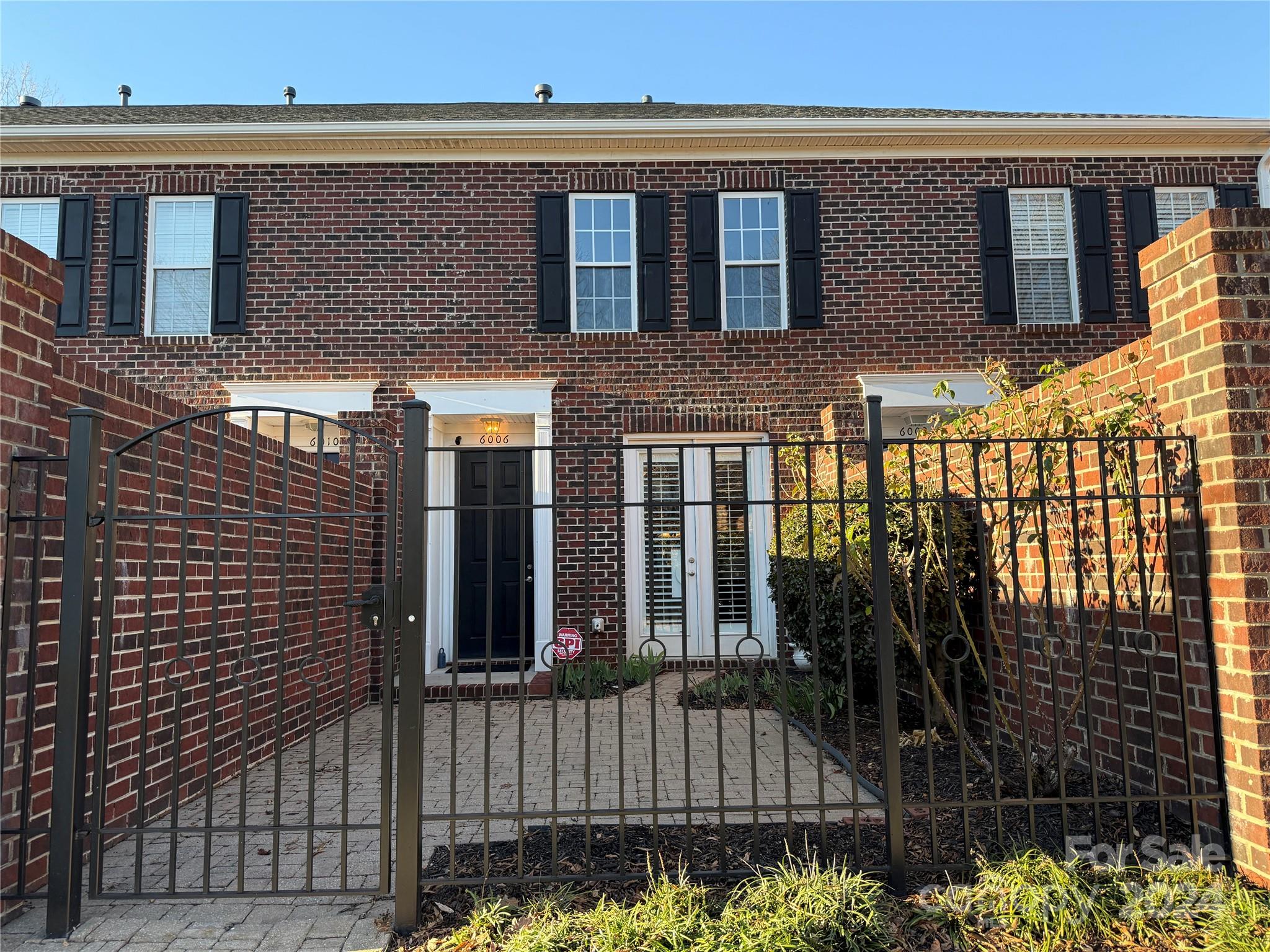 a view of a brick house with many windows