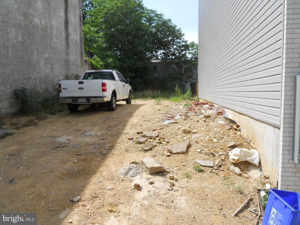 a white car parked in front of a house