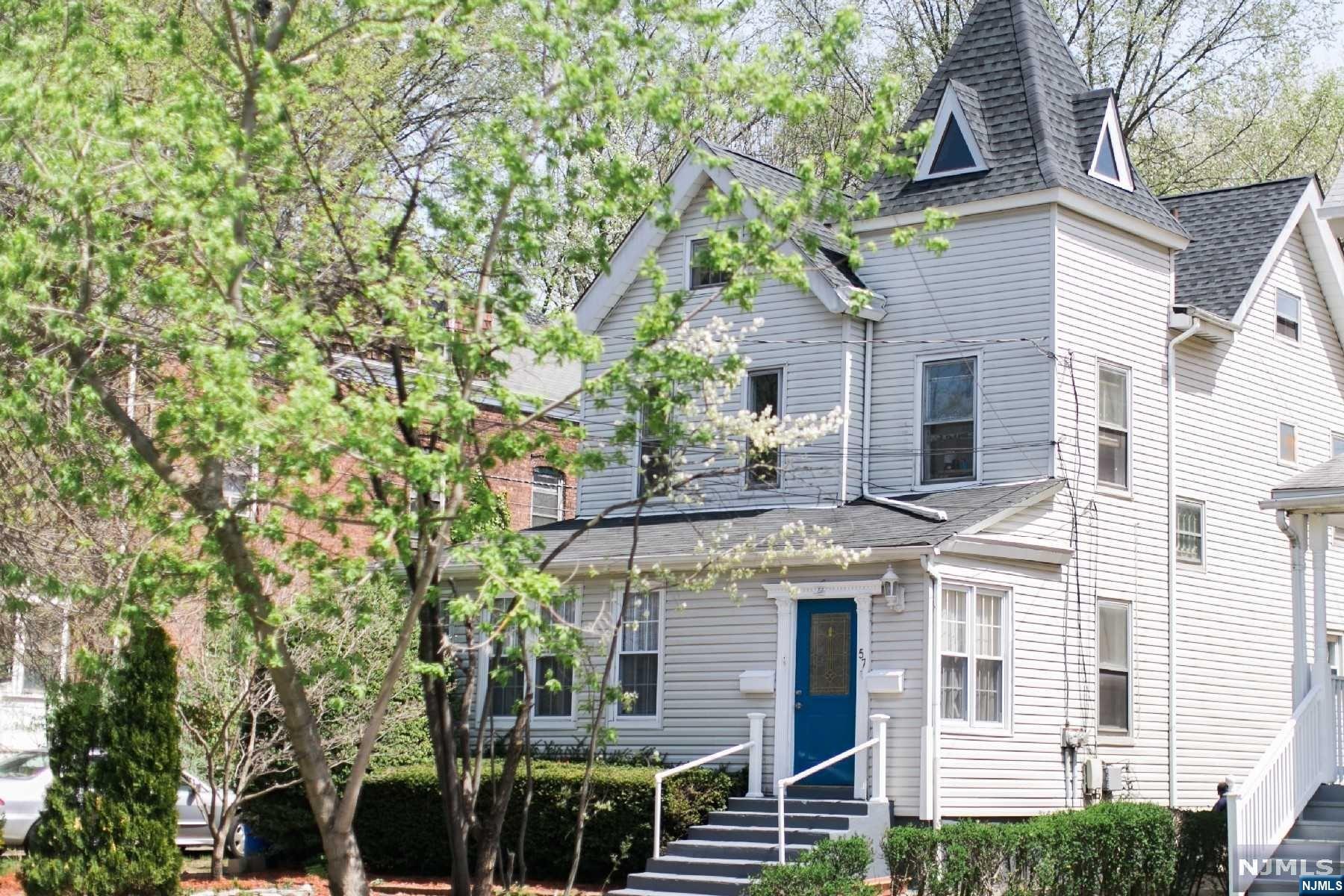 front view of a house with a tree