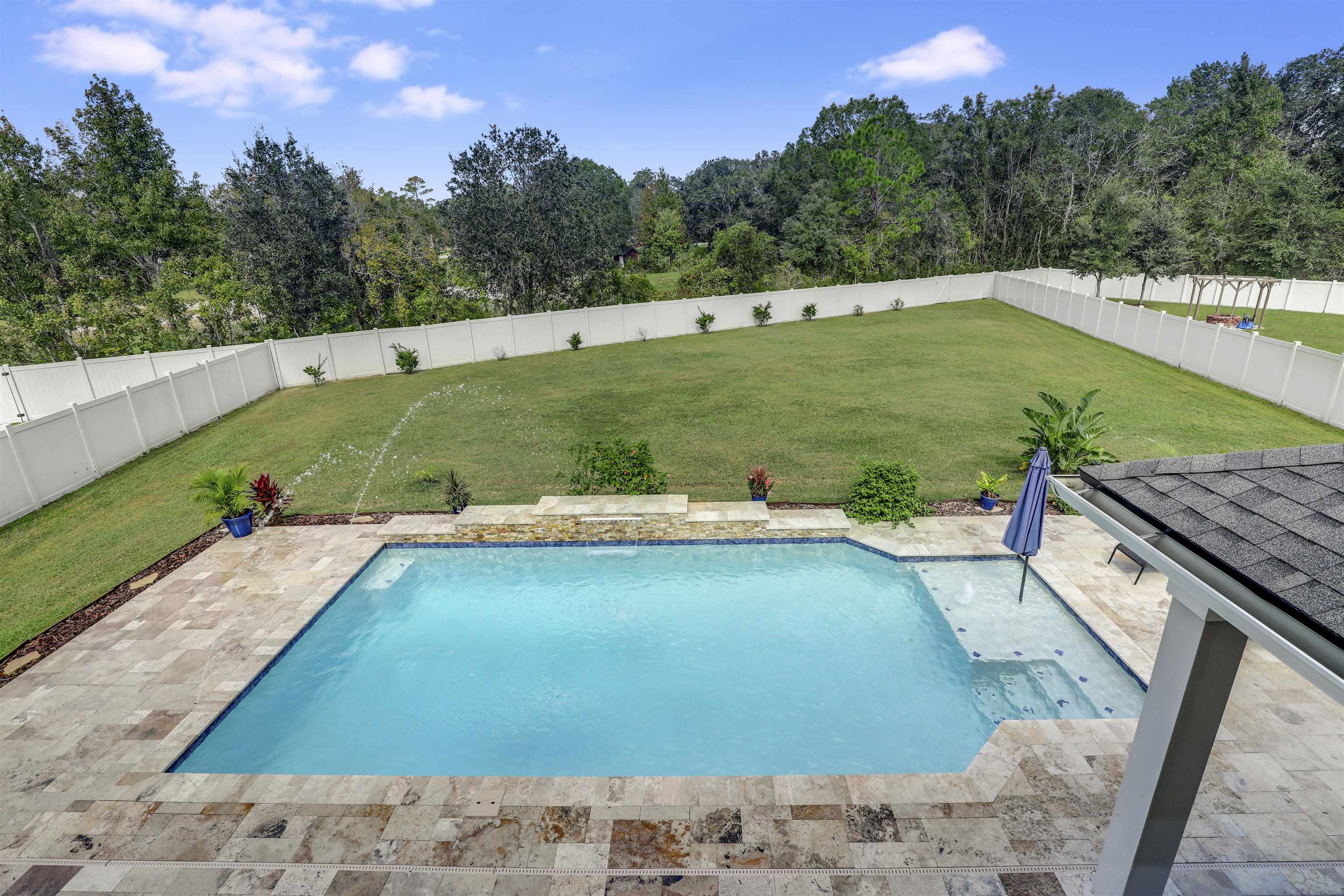 a view of a swimming pool with a yard