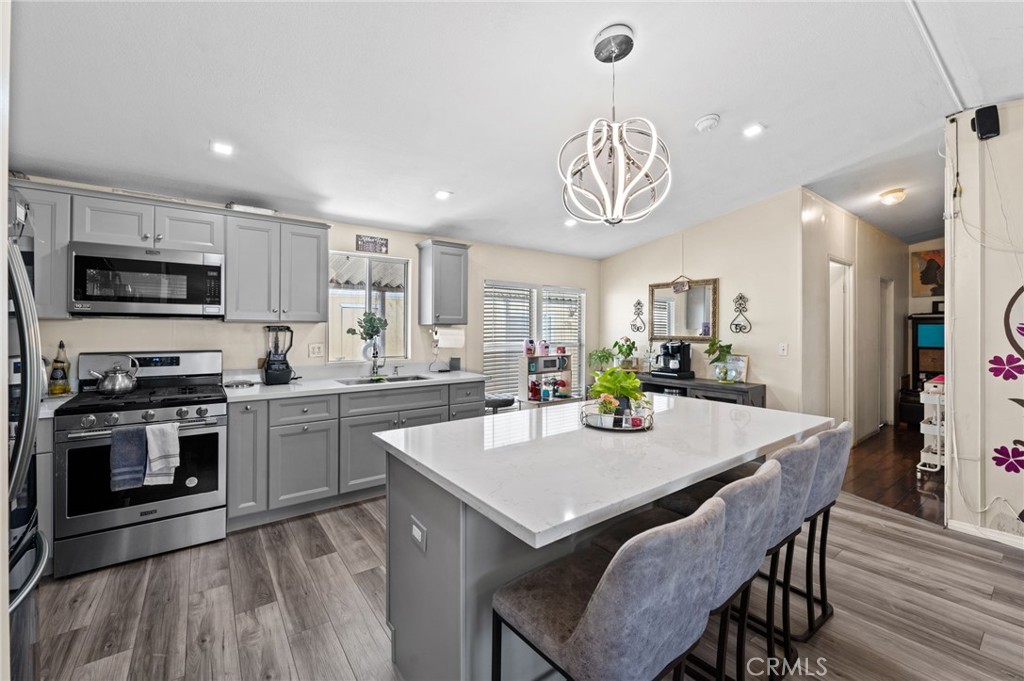 a kitchen with a table chairs stove and microwave