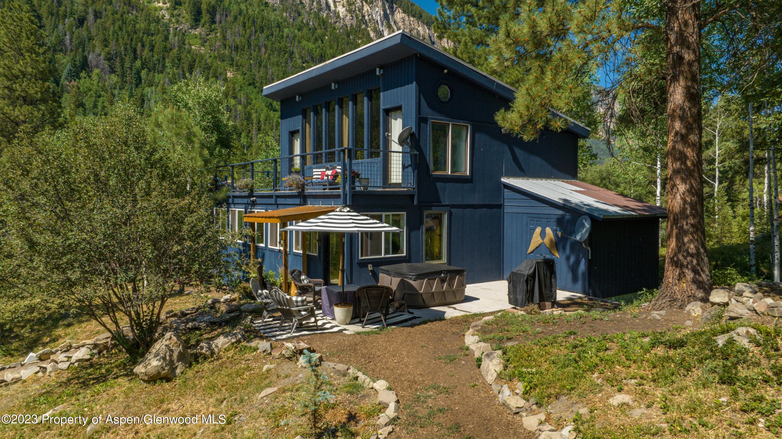 a view of a house with yard and sitting area