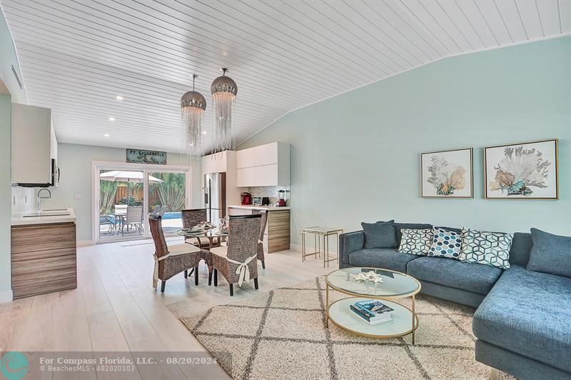 a living room with furniture a dining table and chairs