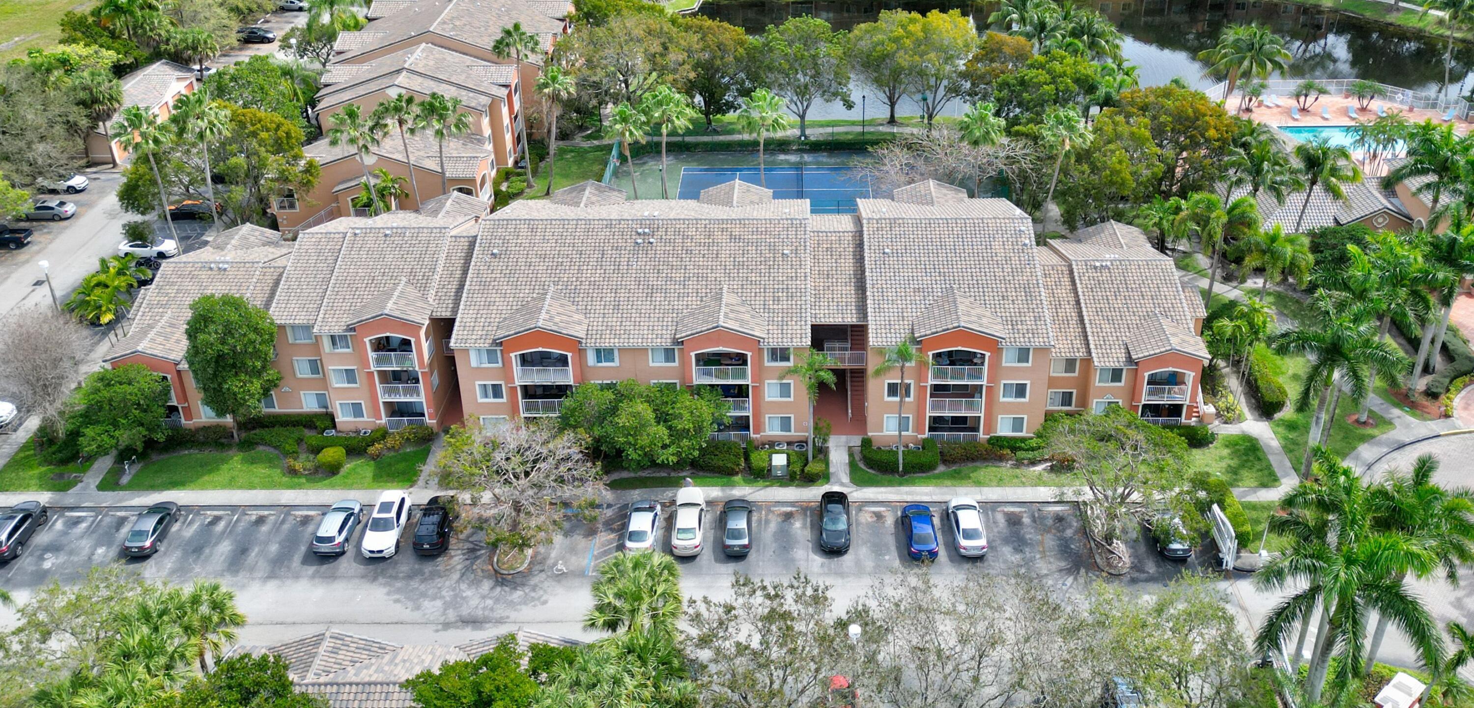 an aerial view of a house with a yard and a wooden fence