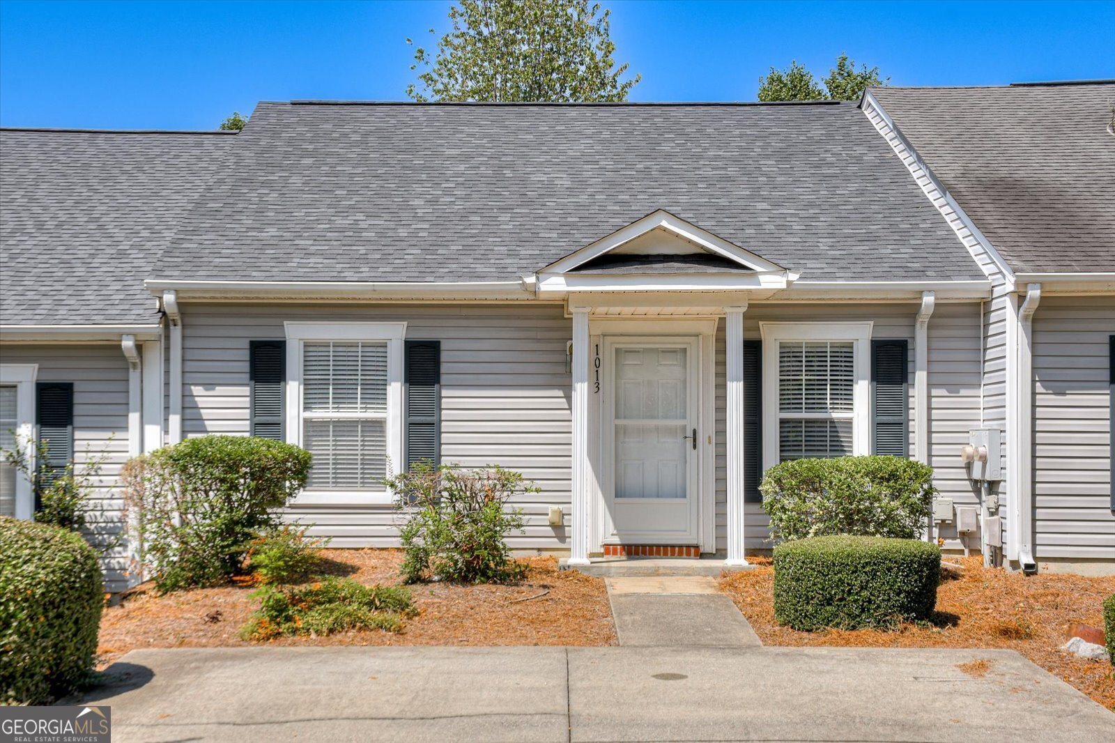 front view of a house with potted plants