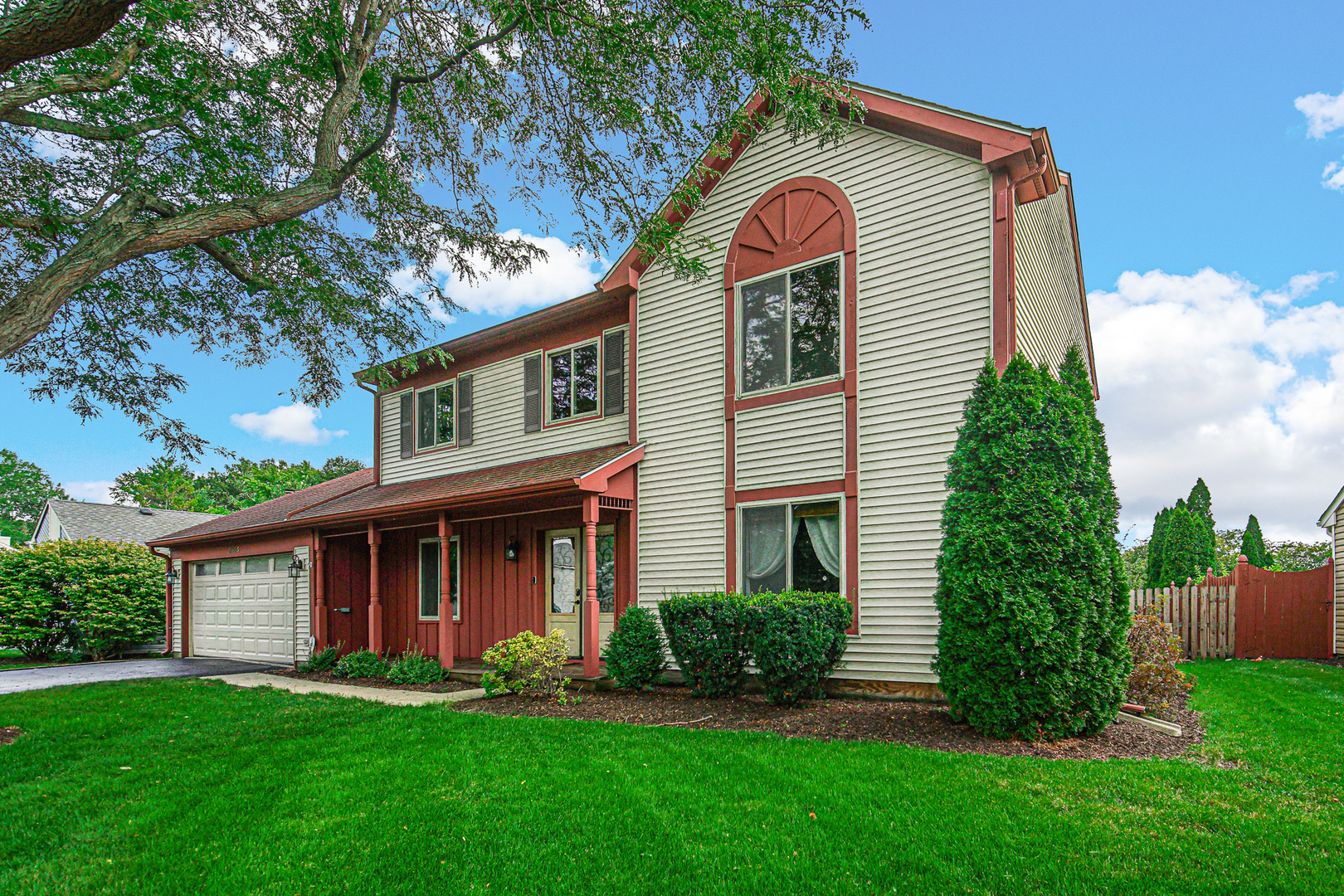 a front view of a house with a yard and porch