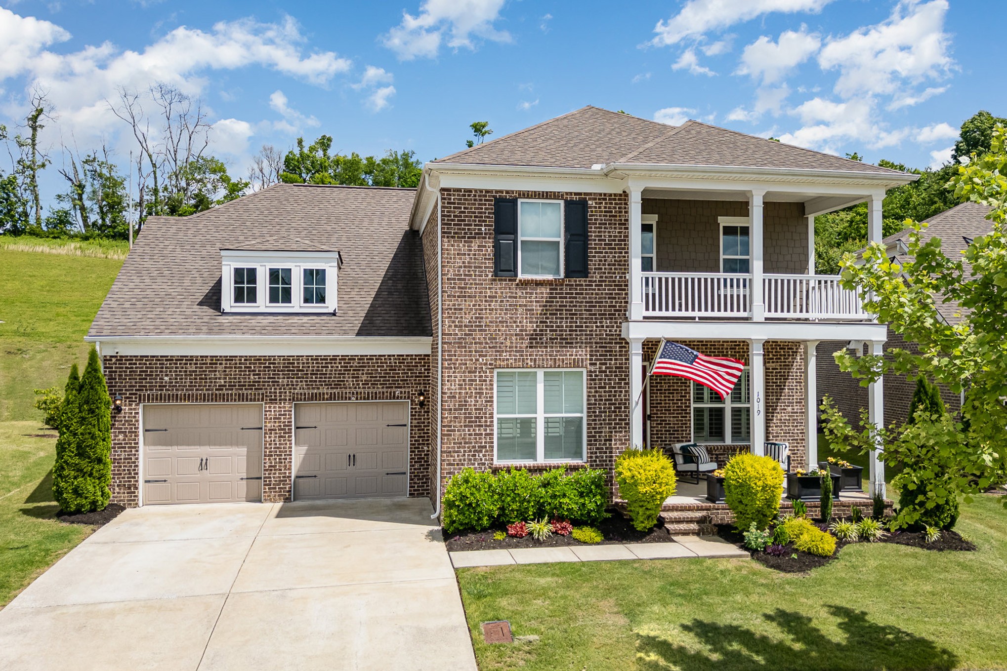 a front view of a house with yard and seating area