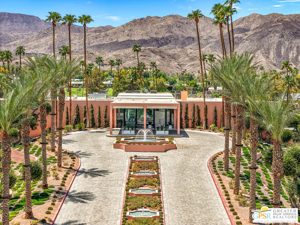 a view of a swimming pool with a patio and a yard