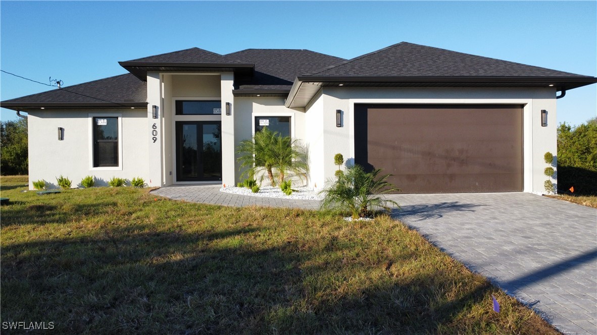 a front view of a house with a yard