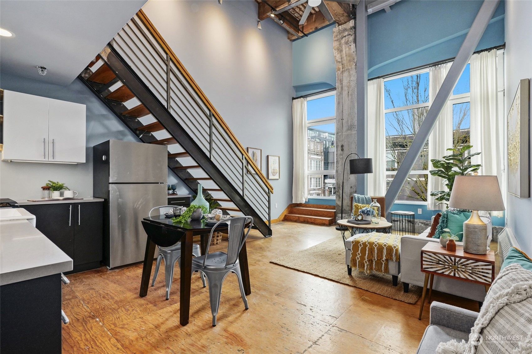 a living room with patio furniture and a kitchen view