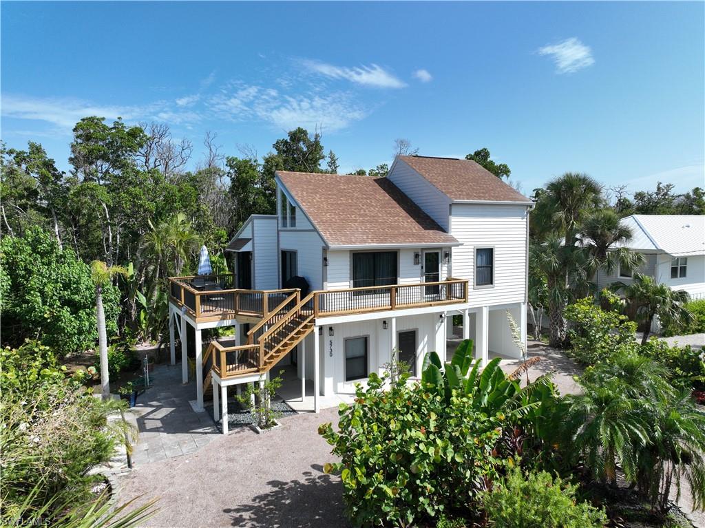 an aerial view of a house with a yard and potted plants