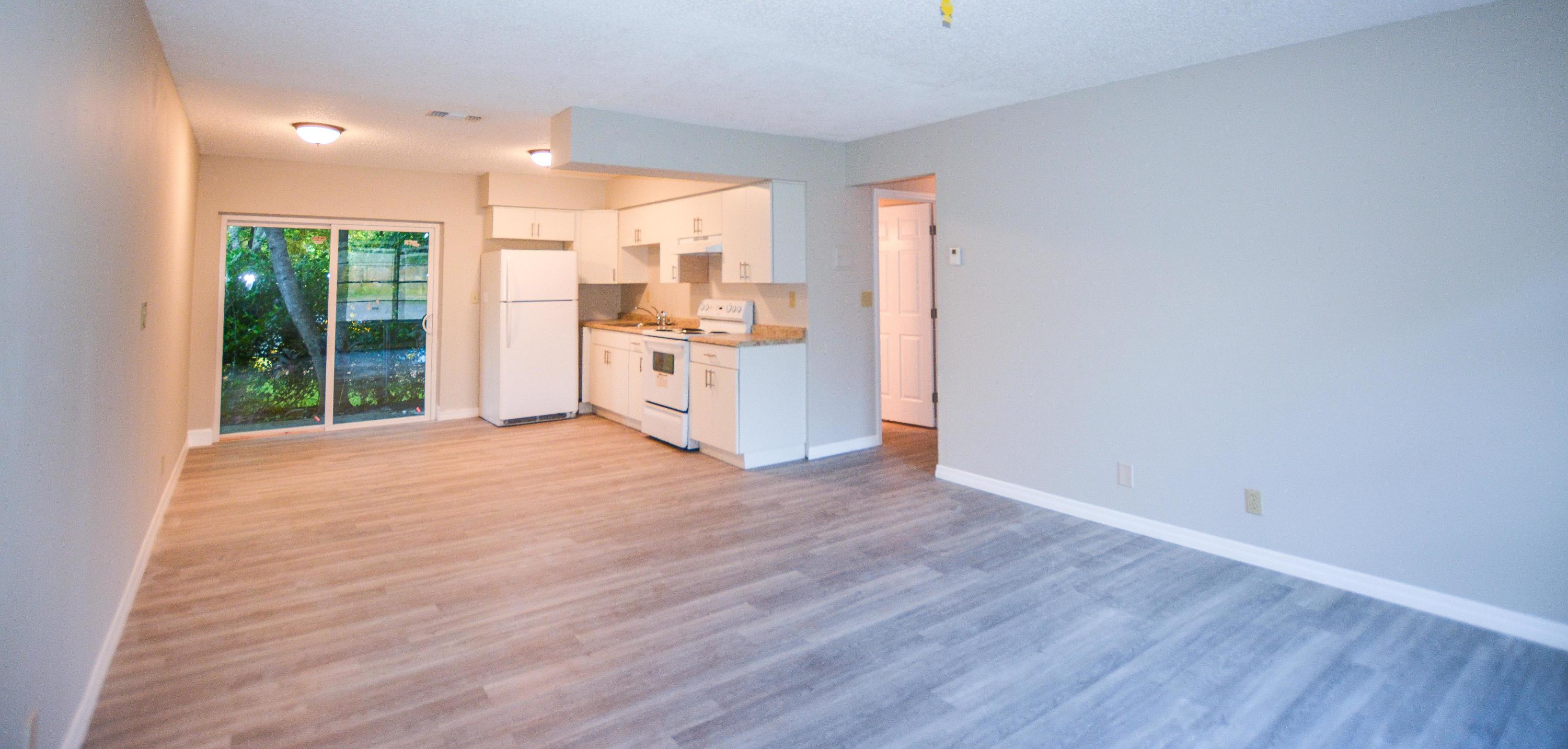 a view of a kitchen with wooden floor and a sink