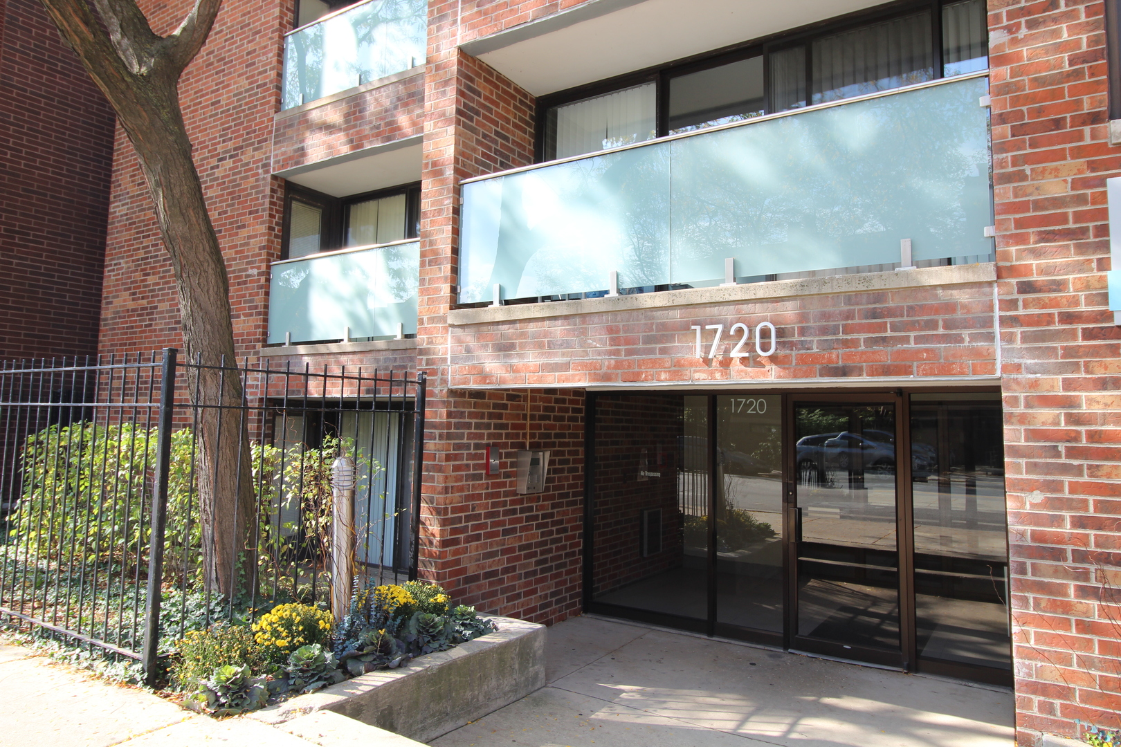 a front view of a building with glass windows and door