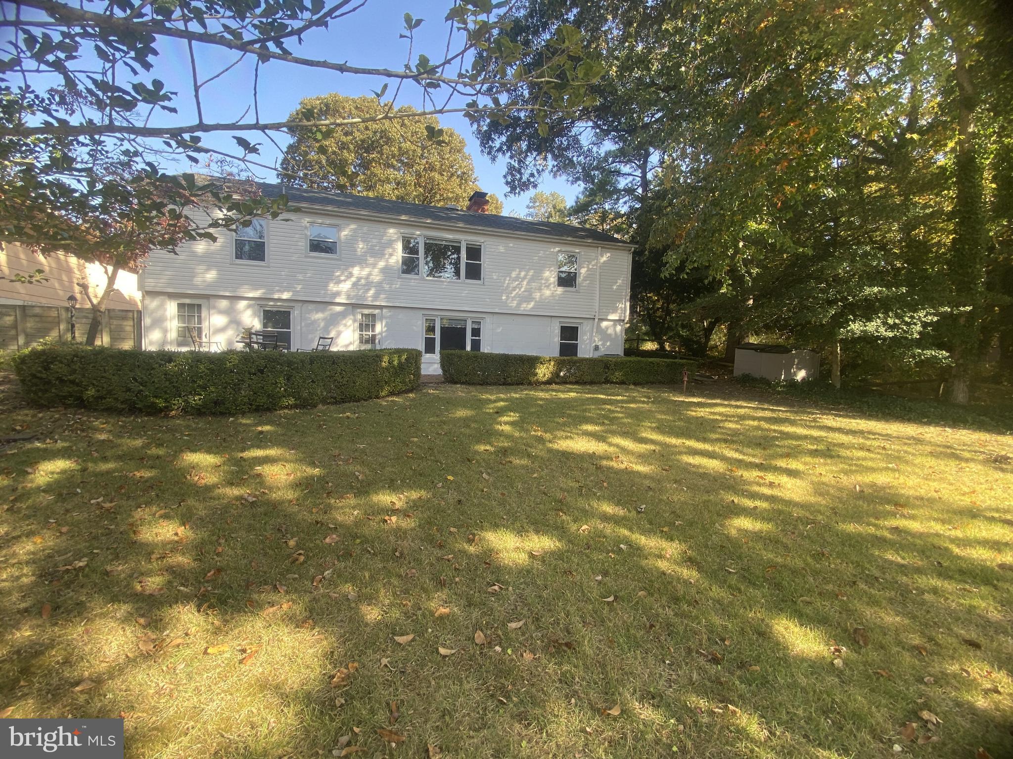 a view of a house with a big yard and large tree