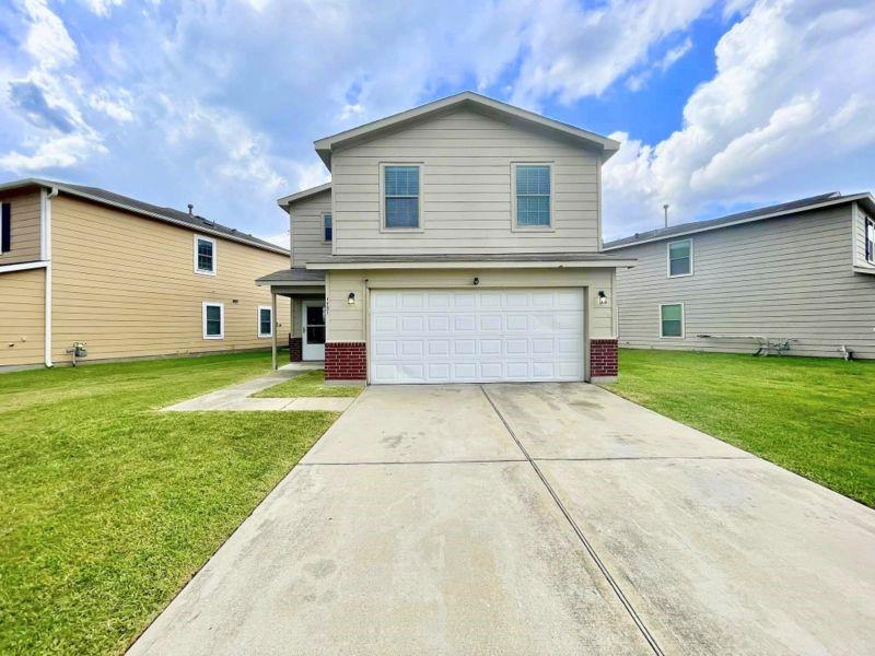 a front view of a house with a yard