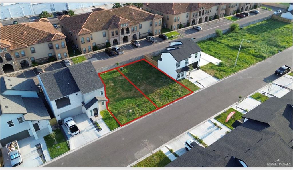 an aerial view of a house with garden space and street view